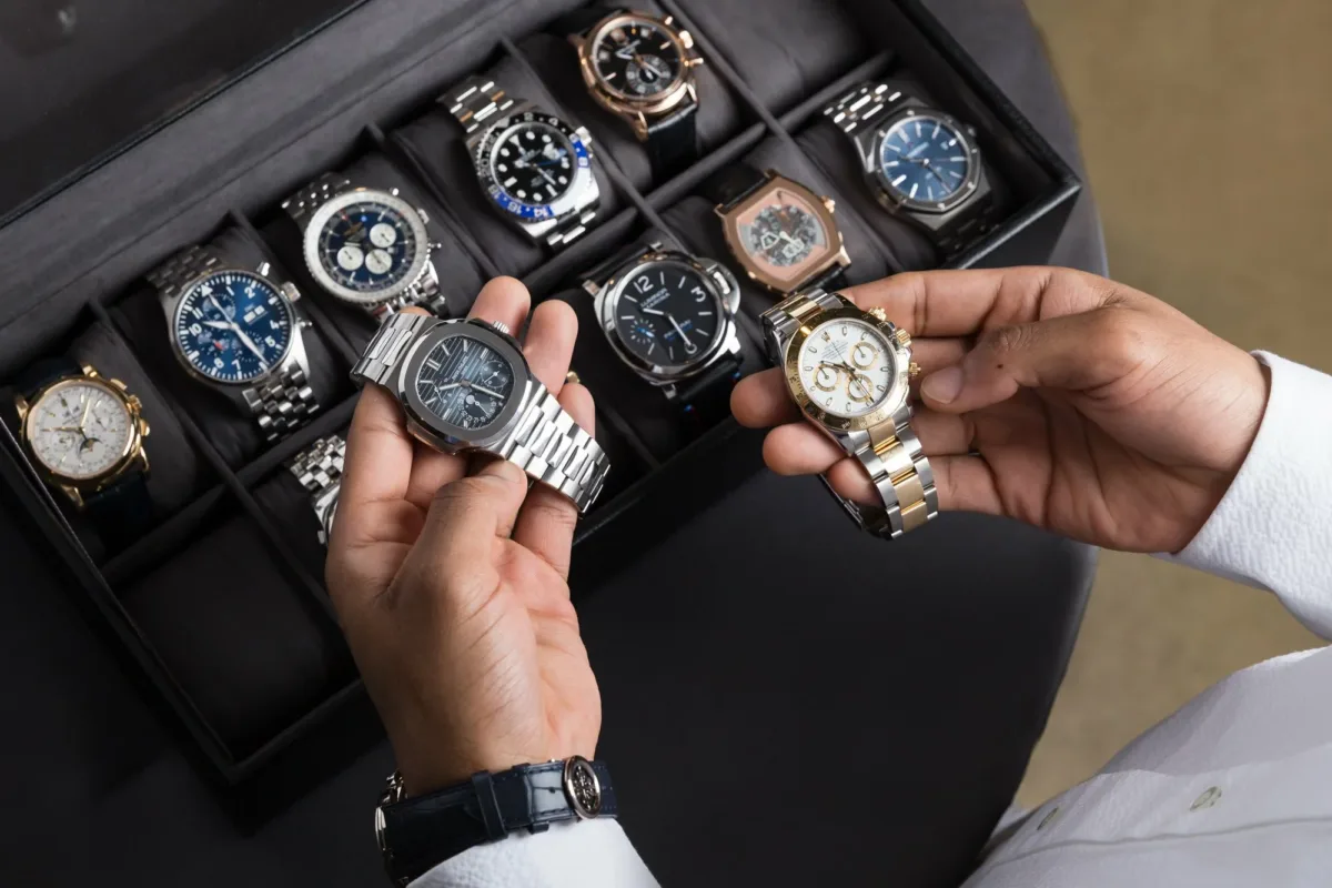 Person examining luxury watches collection. Rise of Luxury Watches as Investment